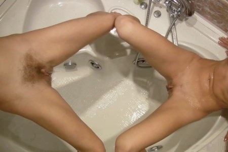 Skinny sisters scour each other in the jacuzzi bath.
