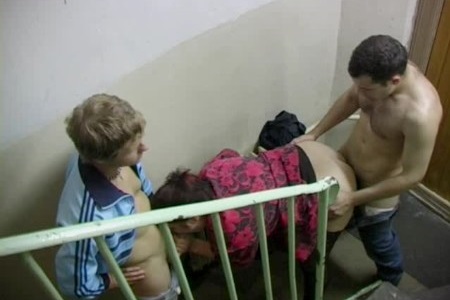 Russian woman fucked on the staircase by two guys and got cum on her face.